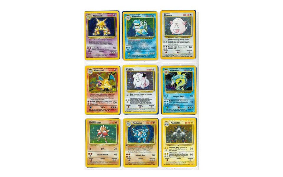 Collection of Pokémon Base Set holographic cards including Charizard, Blastoise, Alakazam, Chansey, Gyarados, Machamp, Clefairy, Hitmonchan and Magneton.